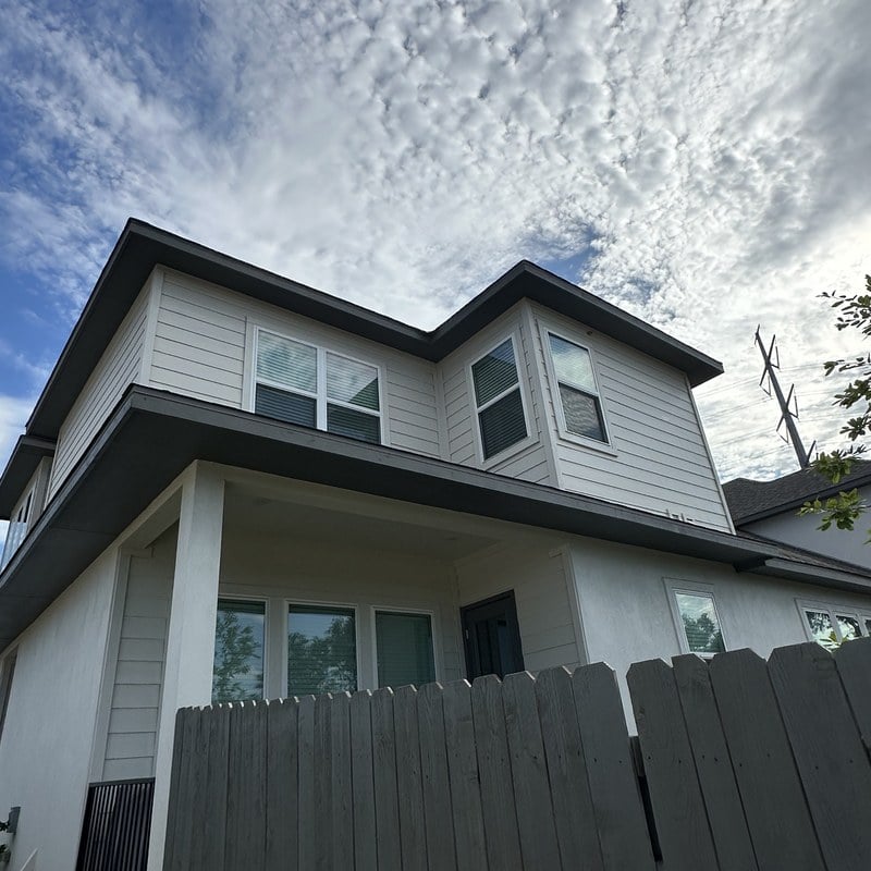 Close-up of a Texas roofline where the color-matched aluminum channel tucks under the soffit.