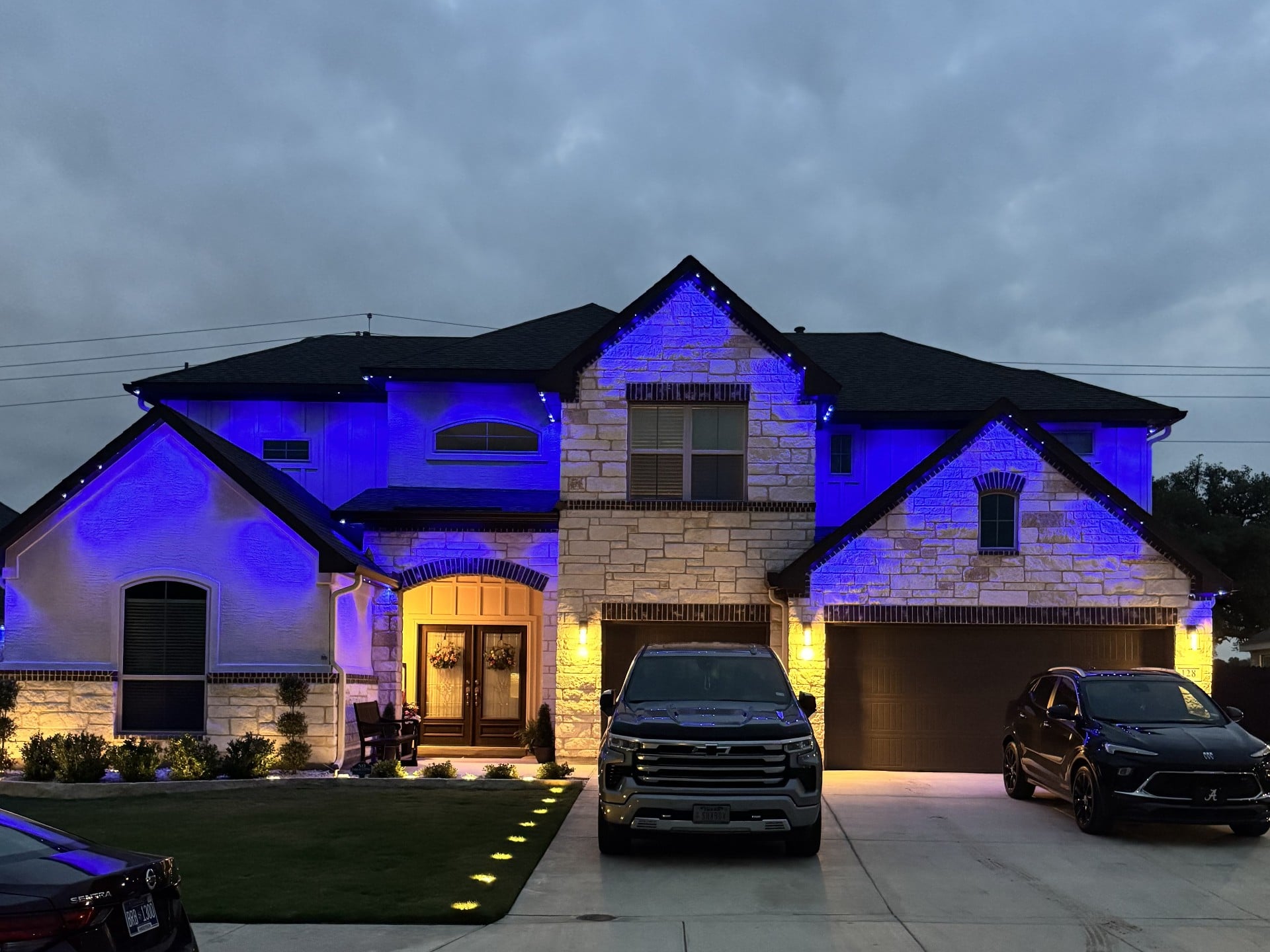 Same Texas home with deep blue permanent LED wash setting the evening mood
