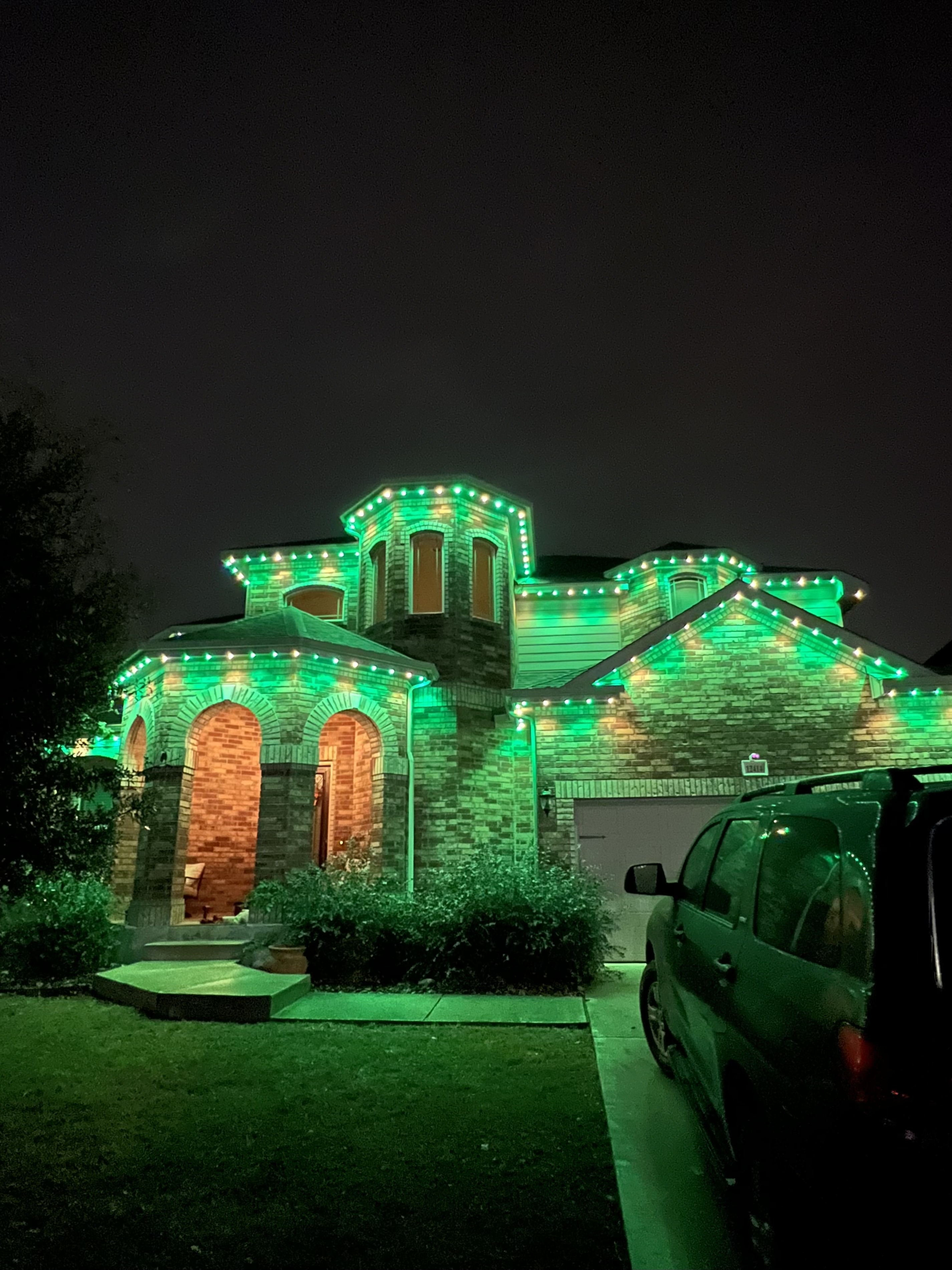 Texas brick home washed in emerald green permanent LED lighting