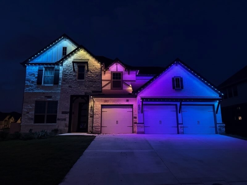 Texas Hill Country home with pink and purple multicolor LED lighting for celebrations